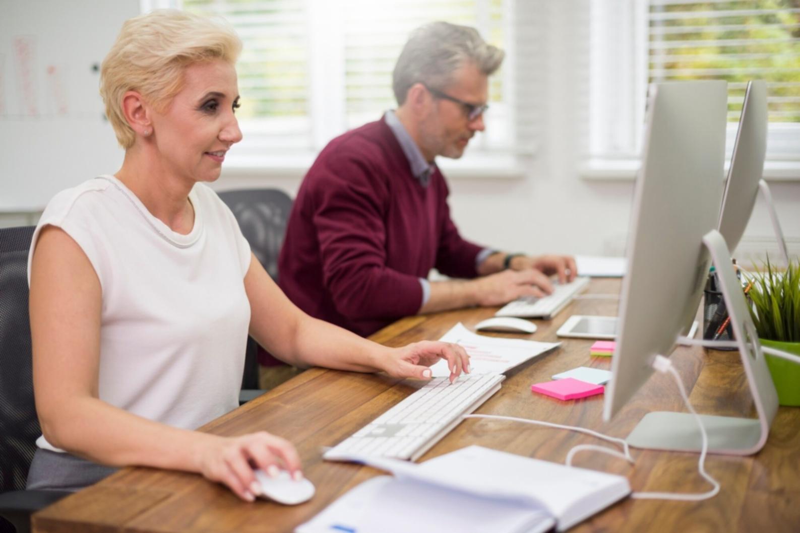 Person reviewing financial documents and planning budget strategy